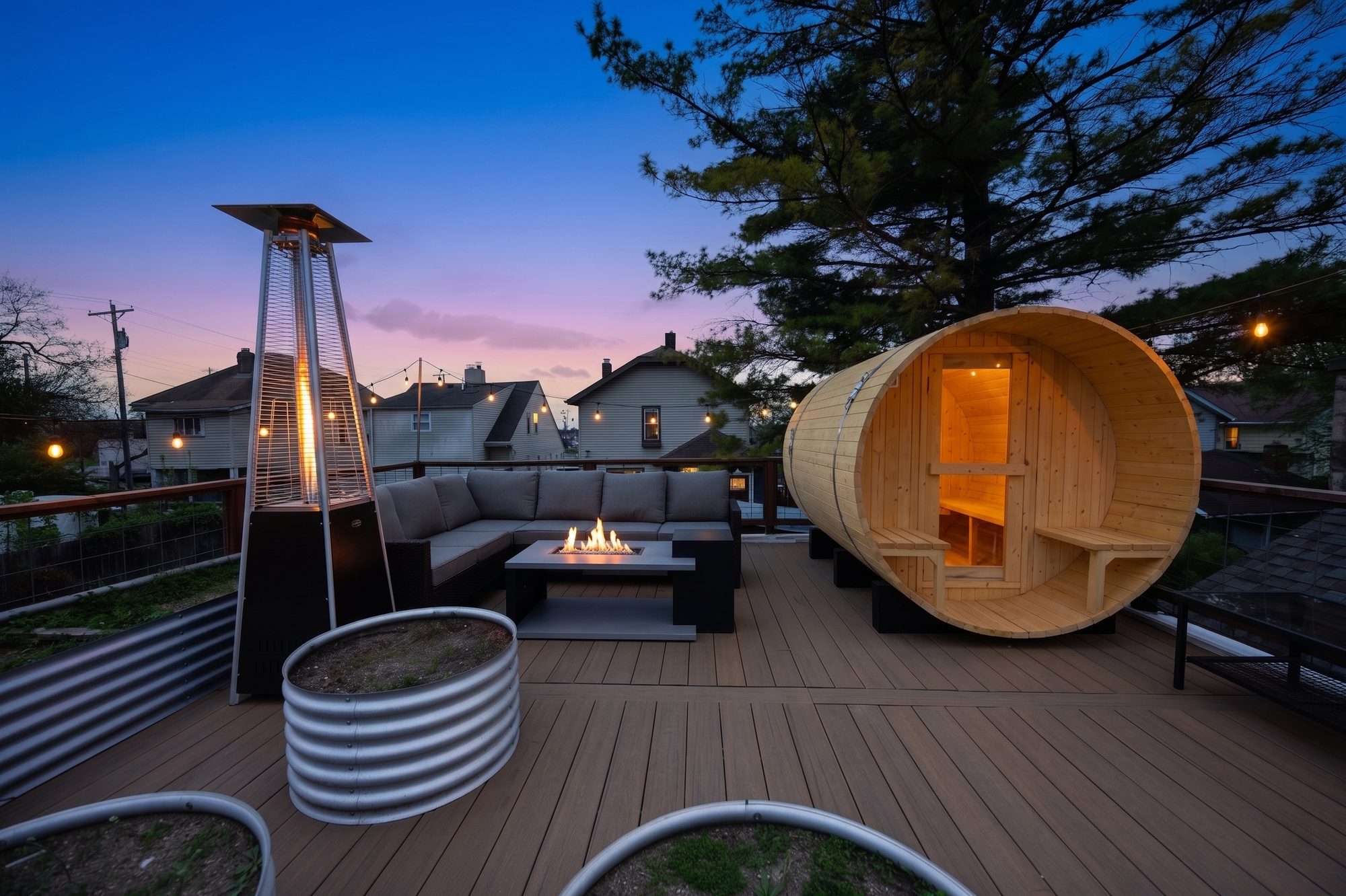 Oak & Echo rooftop at dusk, the barrel sauna glowing beside the fire table