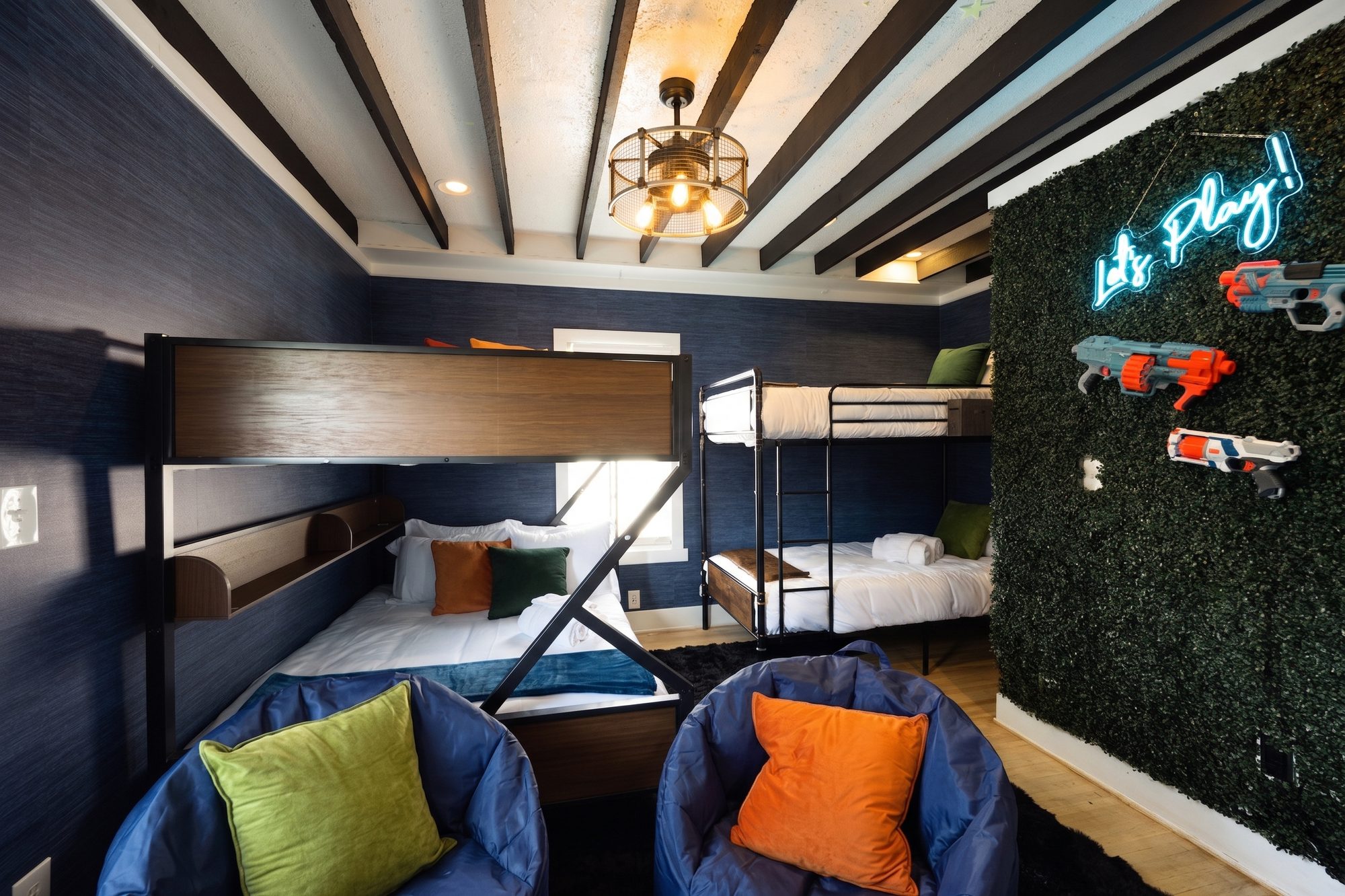 Kids' room with bunk beds, neon sign and Nerf wall